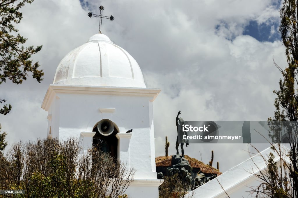 Close-up of bell tower with Monument to the Argentine Heroes of Independence in the background in Humahuaca, Jujuy, Argentina Andes Stock Photo