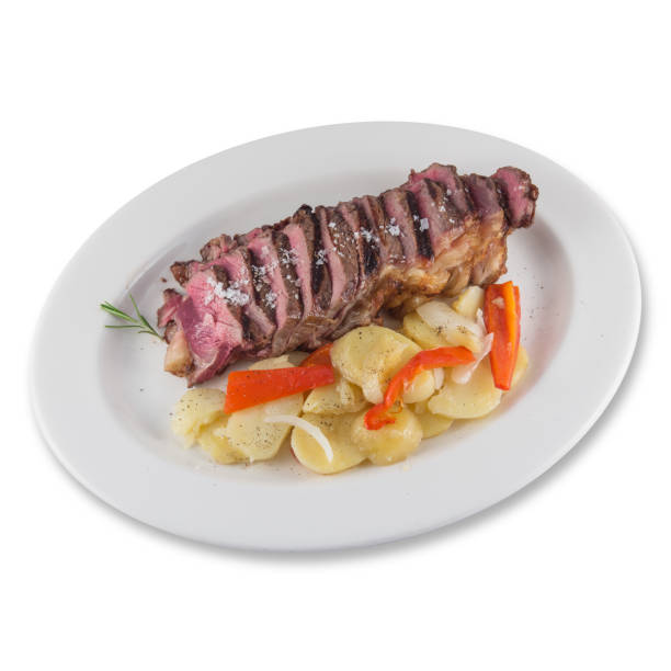 istock Beef cube roll dish with sliced baked potatoes. 1216813835