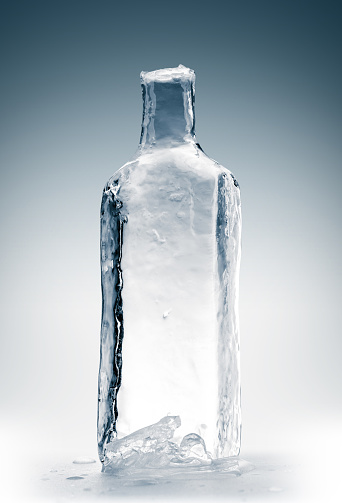 Bottle form, made from clean, transparent ice. Purity and freshness concept.