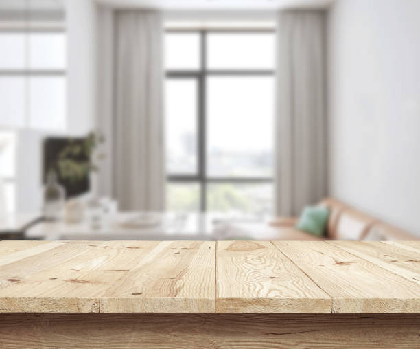istock Concept wooden textured desk with blur interior. 1216818044