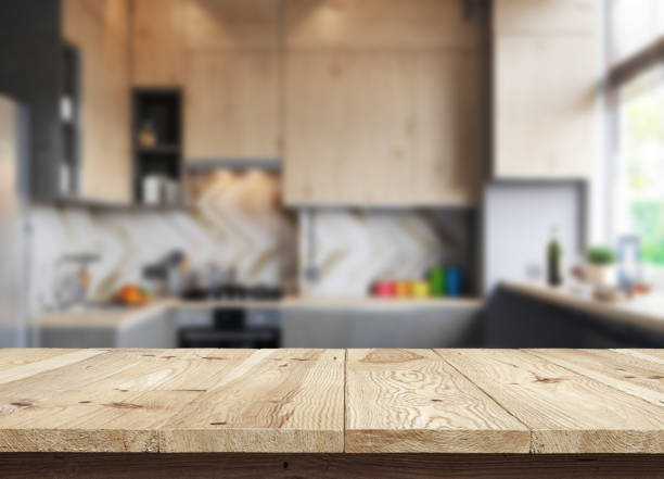istock Concept wooden textured desk with blur interior. 1216818140