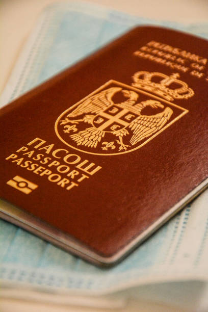 istock Travel restrictions concept. Passport with mask on table 1216819426