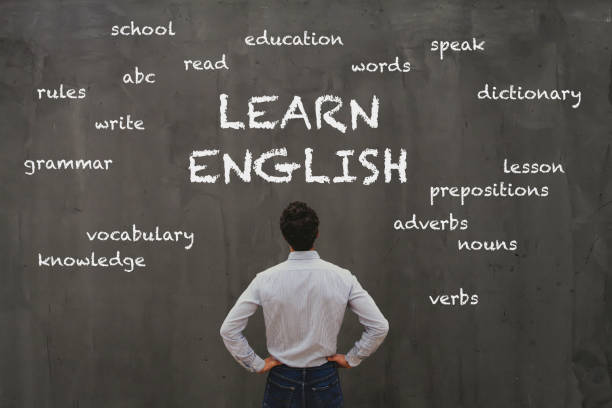 learn english concept learn english concept, business man looking at word cloud on chalk board english culture stock pictures, royalty-free photos & images