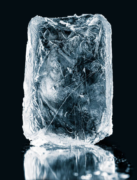 istock Crystal clear natural ice block on  black reflective surface. Clipping path included. 1216820576