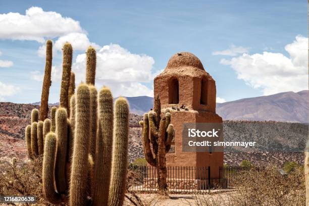 Adobe Bell Tower With Birds Next To Several Cactus In Humahuaca Jujuy Argentina Stock Photo - Download Image Now