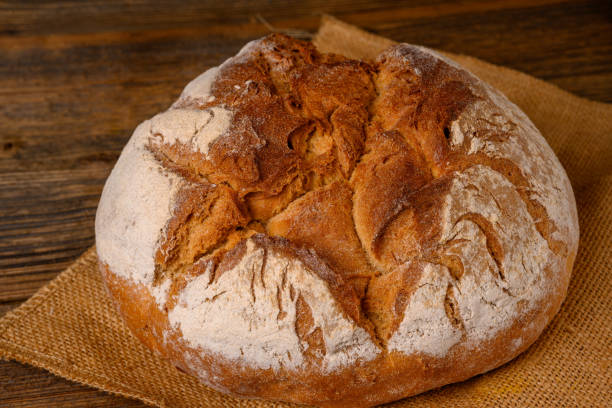 istock A fresh whole grain bread from the baker on a jute fabric on a rustic wooden background 1216820721