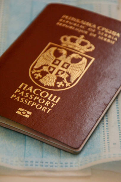 istock Travel restrictions concept. Passport with mask on table 1216821565
