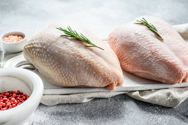 Raw chicken Breasts, fresh fillets with skin. Organic farm bird. Gray background Raw chicken Breasts, fresh fillets with skin. Organic farm bird. Gray background. turkey breast stock pictures, royalty-free photos & images