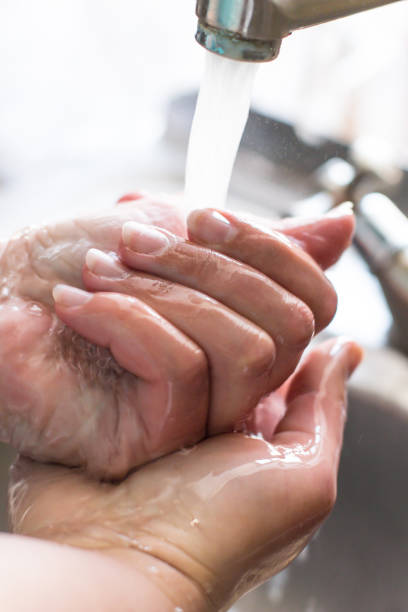 istock Wash hands with soap for coronavirus. Female hands with manicure in a kitchen sink 1216823933