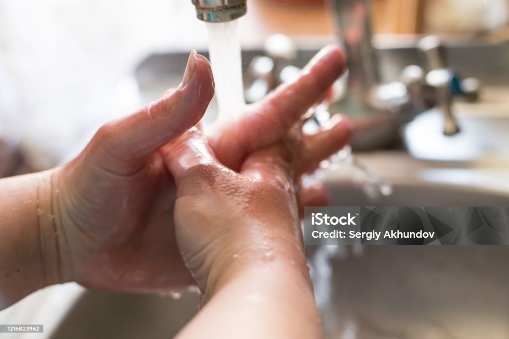 Wash your hands often with coronavirus Girl washes hands under the tap close-up. Wash your hands often to prevent virus infection. Bacterium Stock Photo