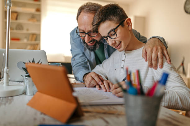 istock Happy father helping son with homework 1216824592