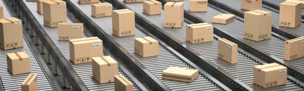 istock Cardboard boxes on the conveyor belt. Production, storage and delivery concept background. 1216827846
