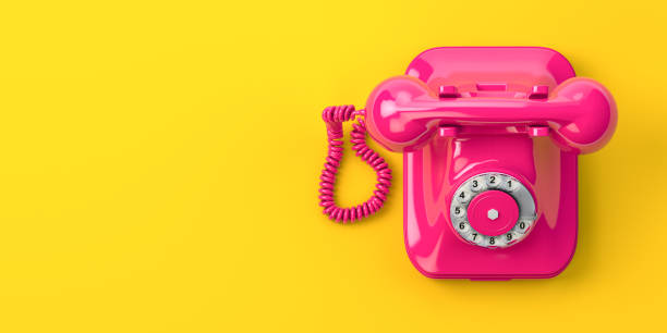istock Vintage pink telephone on yellow background. 1216828122