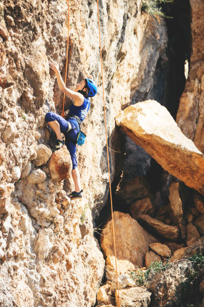 istock Girl climbs a rock. 1216828706