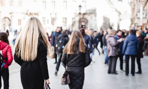 istock Blurred background. Blurred people walking through a city street. Crowd 1216828923