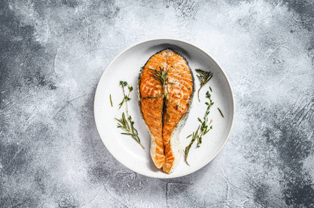 istock Grilled salmon steak. Atlantic fish. Gray background. Top view. Space for text 1216829420