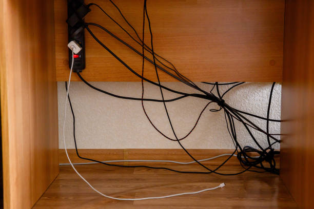 istock Surge Protector, charger, tangled wires and cable under the table 1216831055