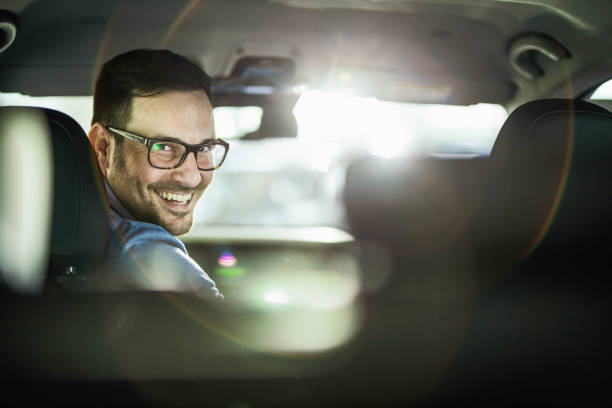 istock Young happy man parking his car in a reverse. 1216832605