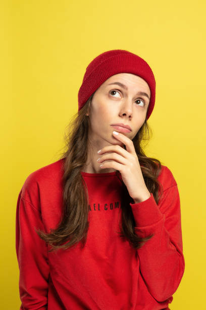istock Young woman thinking and looking up 1216834015