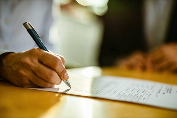 istock Close up of unrecognizable person signing a contract. 1216834150