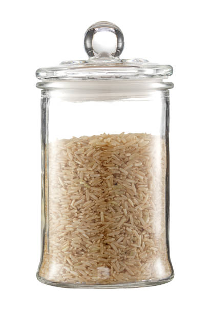 istock Rice in a transparent glass container. Isolated on a white background. 1216834237
