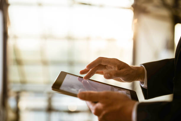 istock Close up of unrecognizable businessman using digital tablet. 1216835558