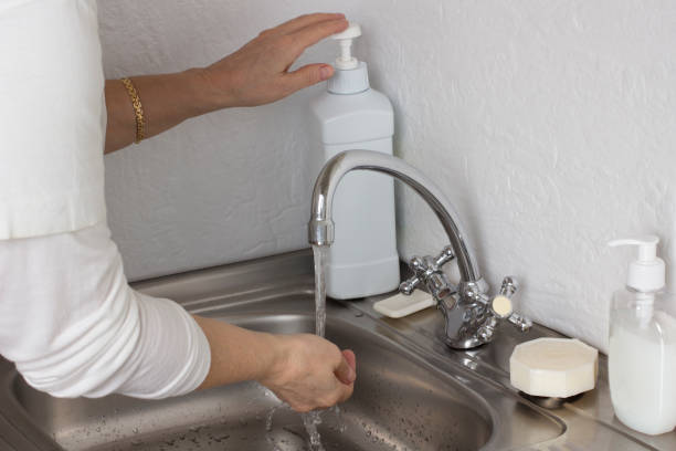 istock Hand under water from tap. Hand use soap from washing dispenser 1216835695