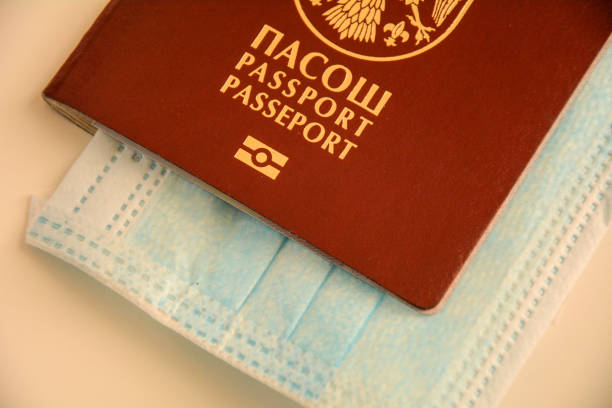 istock Coronavirus concept background. Passport and surgical mask 1216836473