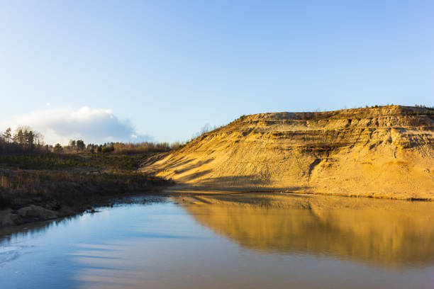 istock sand mountain quarry and water lake landscape 1216838147