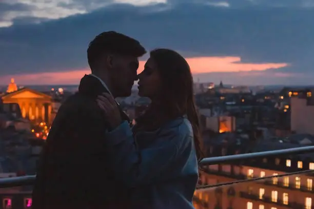 Photo of love, couple kissing on night city skyline view