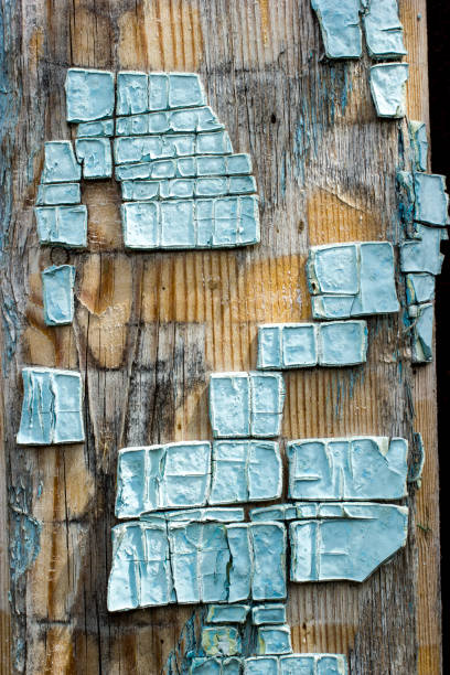 Part of old wooden boards painted in light blue cracked paint with several layers of shelled paint pieces Part of old wooden boards painted in light blue cracked paint with several layers of shelled paint pieces eschar stock pictures, royalty-free photos & images