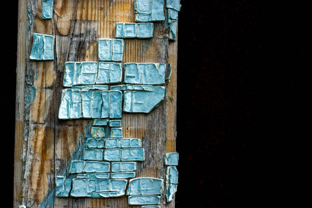 Part of old wooden boards painted in light blue cracked paint with several layers of shelled paint pieces Part of old wooden boards painted in light blue cracked paint with several layers of shelled paint pieces eschar stock pictures, royalty-free photos & images