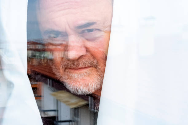 istock Senior Man Longing for Freedom in Coronavirus Quarantine 1216842928
