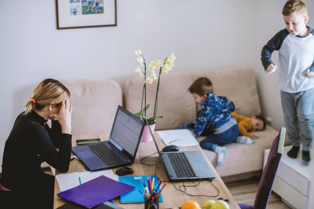 istock Mother working from home with young children in quarantine isolation 1216843240