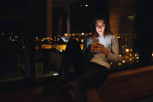 istock Tired woman looking at her phone during town lock-down 1216844259