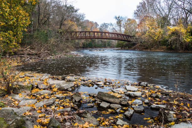 Red footbridge over the Tulpehocken Creek in autumn stock photo