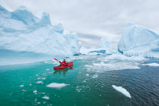 istock man paddling on kayak between ice in Antractica 1216846428