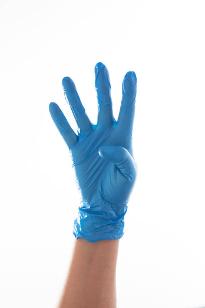 istock Hand in blue glove showing number four with fingers. 1216846815