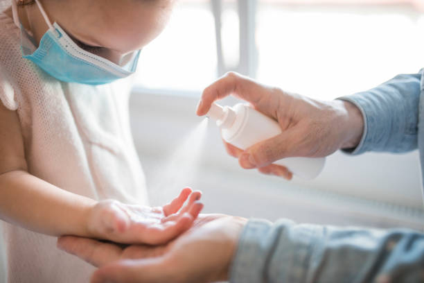 istock Father and child using sanitize antiseptic for hand coronavirus protection 1216852086