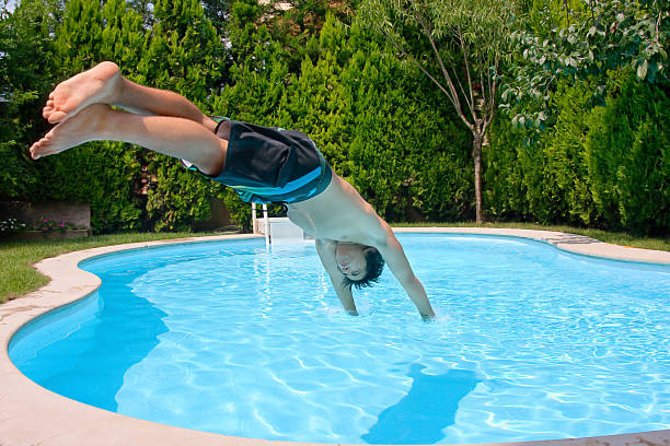 Jumping to pool stock photo