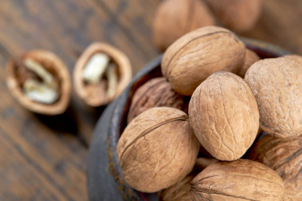 istock group of fresh raw walnuts grunge wooden background. rustic and detailed image. 1216855202