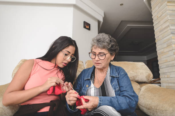 Grandmother teaching her granddaughter to crochet Grandmother teaching her granddaughter to crochet crochet photos stock pictures, royalty-free photos & images