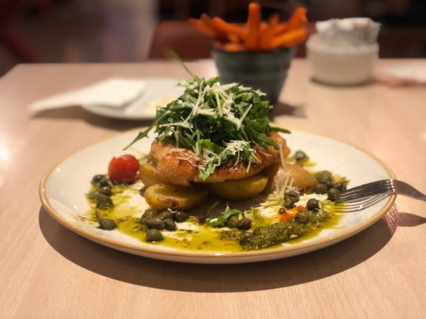 istock Tasty chicken schnitzel with potatoes and pesto 1216859614