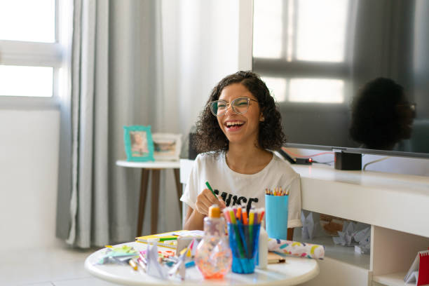 istock Teenager girl laughing while drawing 1216859859