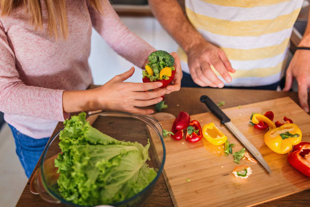istock Young unrecognizable couple preparing lunch at home 1216860844