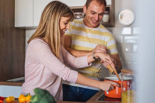 istock Young couple cooking together in the kitchen 1216861733