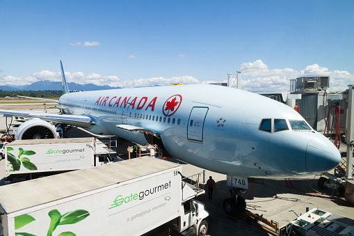 Vancouver, Canada - July 3, 2017: An Air Canada Airlines Boeing 777 plane being serviced on the tarmac of Vancouver International Airport.
