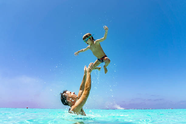 istock Father is tossing up a son in the air 1216865640