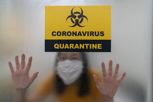 self isolation photo of Asian woman stay in quarantine room for social distancing in hospital
