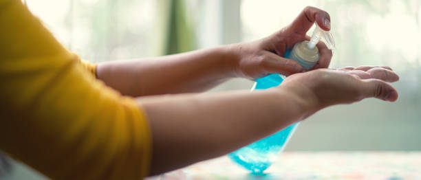 istock Chinese woman using alcohol gel for cleaning her hand 1216865705